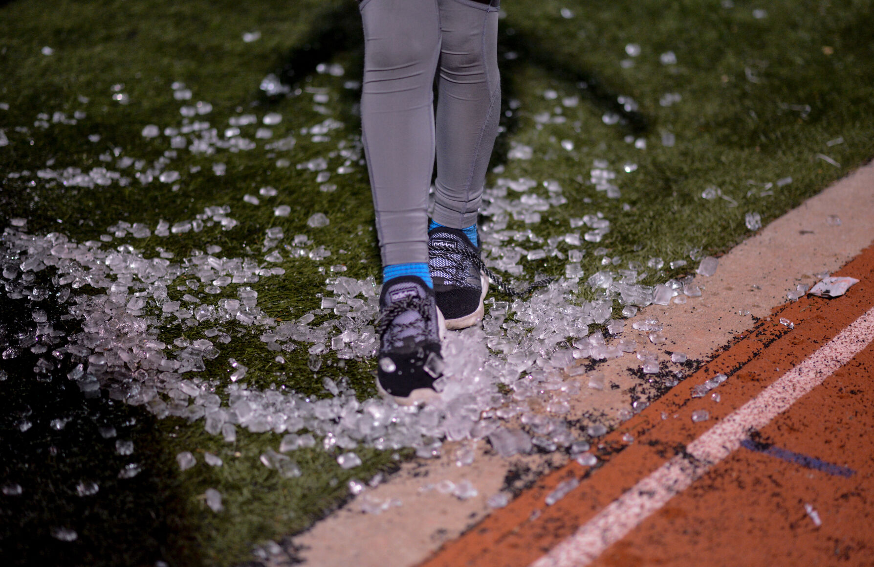 Noah Dent, 9, spreads ice around on the ground